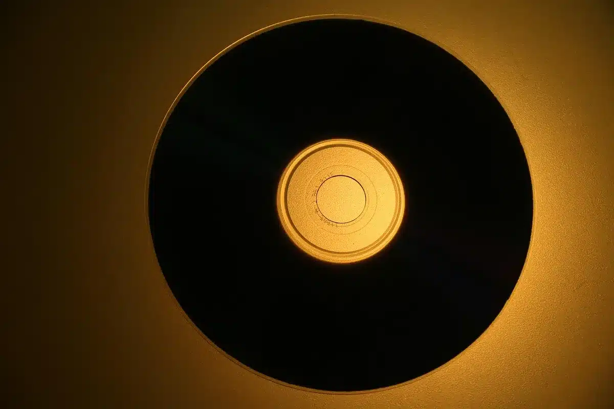 Stack of scratched pop-punk CD singles on a table