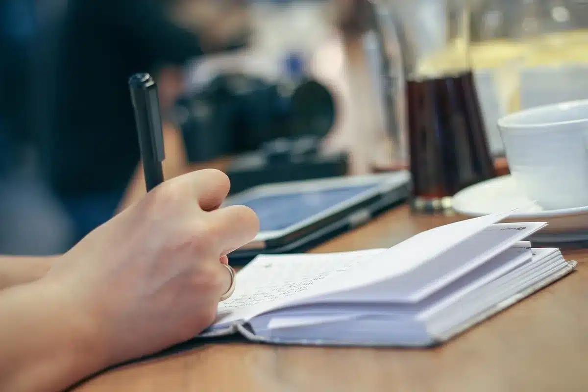 Timer, notebook and pen ready for a five-minute task to build momentum