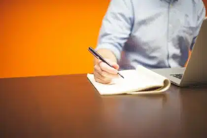 Desk with notebook, kitchen timer and closed laptop suggesting focus and task-starting