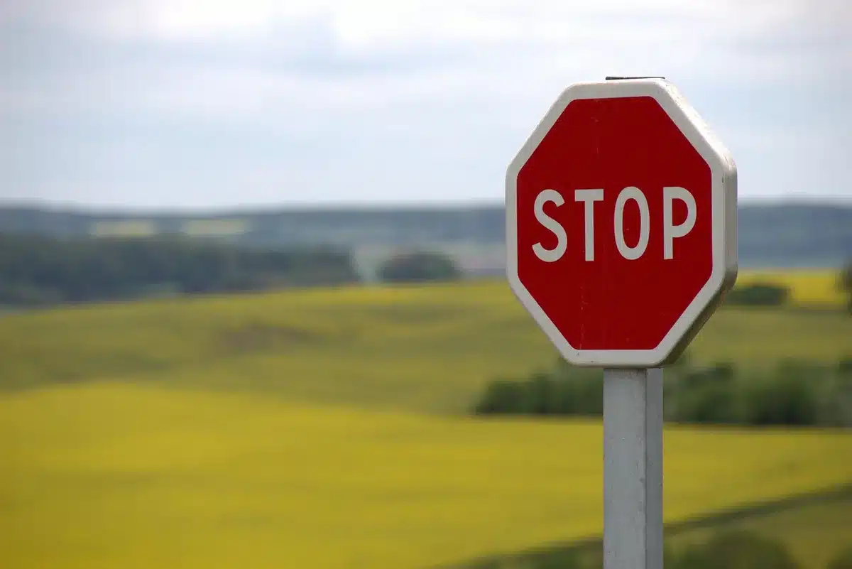 Warning sign on a lonely road suggesting danger and risk