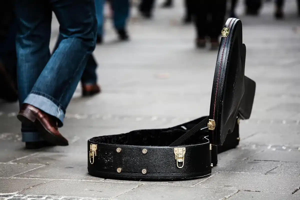 Backstage corridor with guitar case and silhouetted hand, moody but anonymous