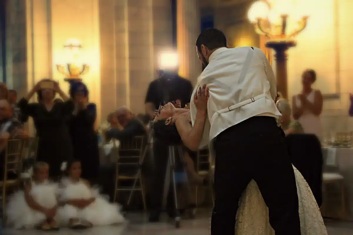 Guests dancing together on a dance floor at a wedding celebration