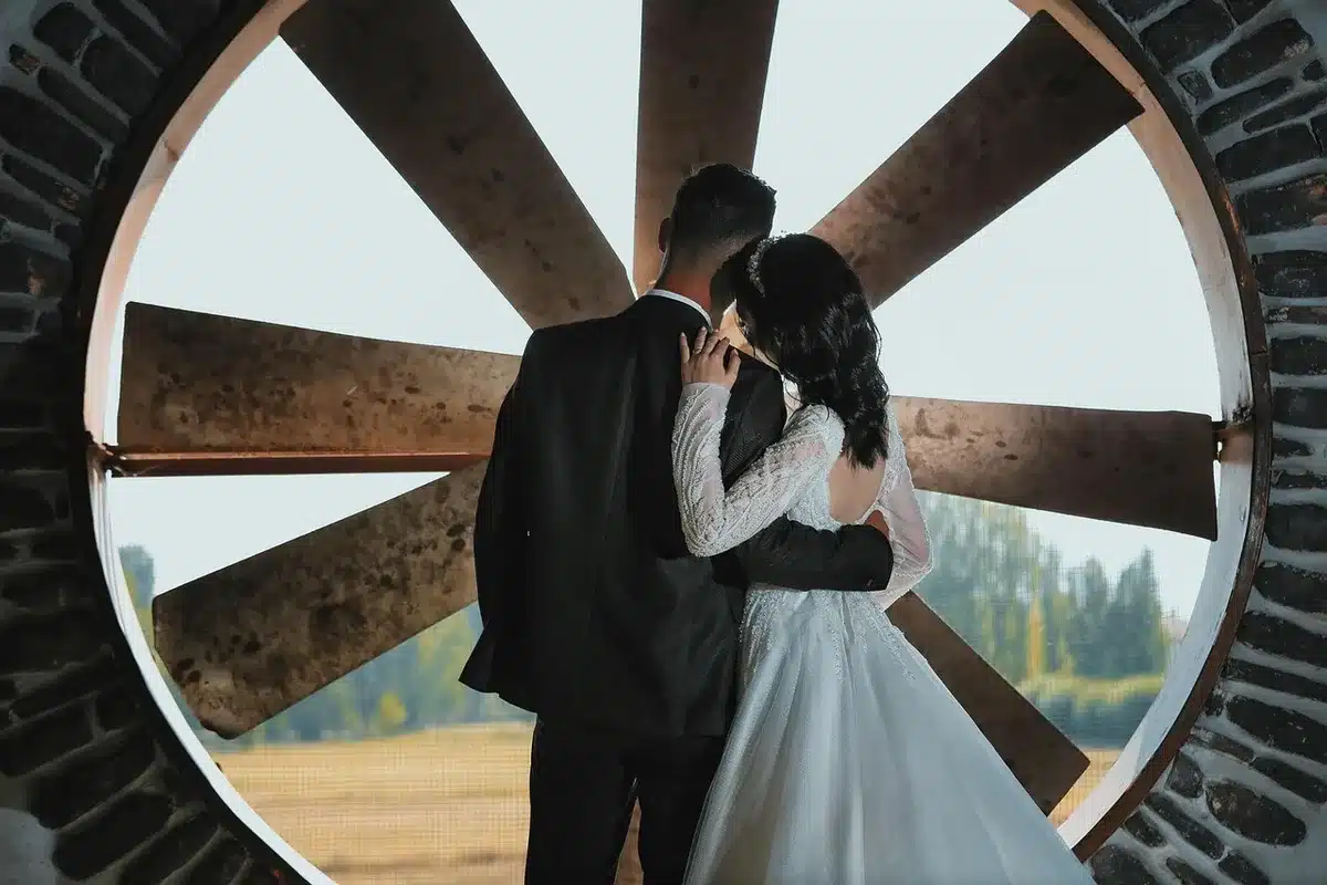 Couple dancing together during their first dance at a wedding reception with warm lighting