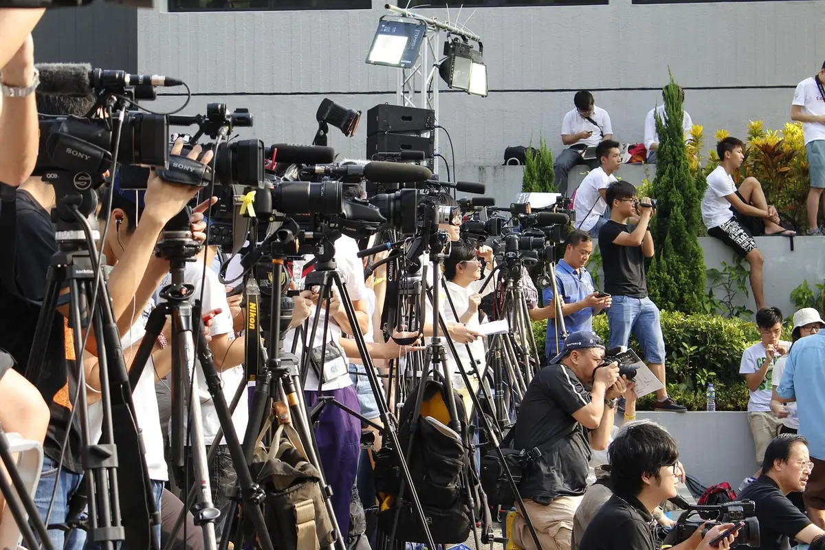 Damaged large-screen TVs and scattered equipment in a backstage area