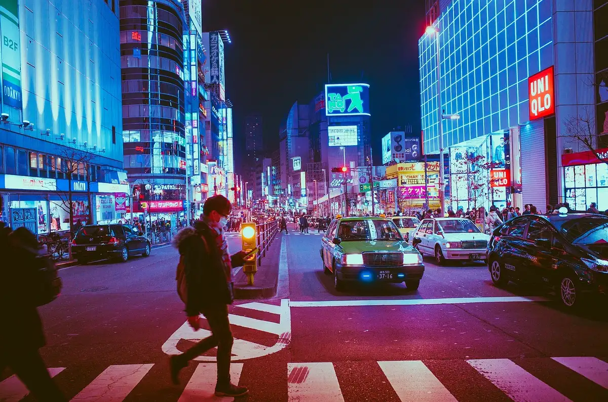 Silhouette of a lone detective on a neon-lit rainy street with holographic signs