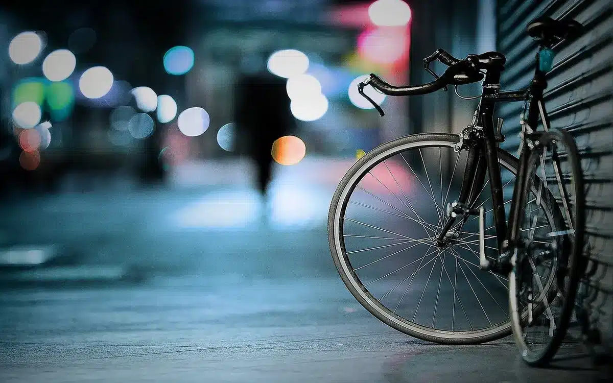 Silhouette of a solitary figure standing in an urban night street