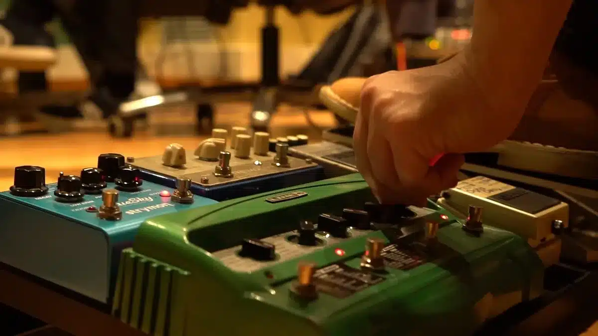 Close-up of guitar pedals and cables creating atmospheric stage texture