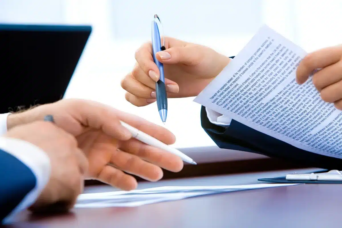 Legal complaint and music contracts laid out on a desk