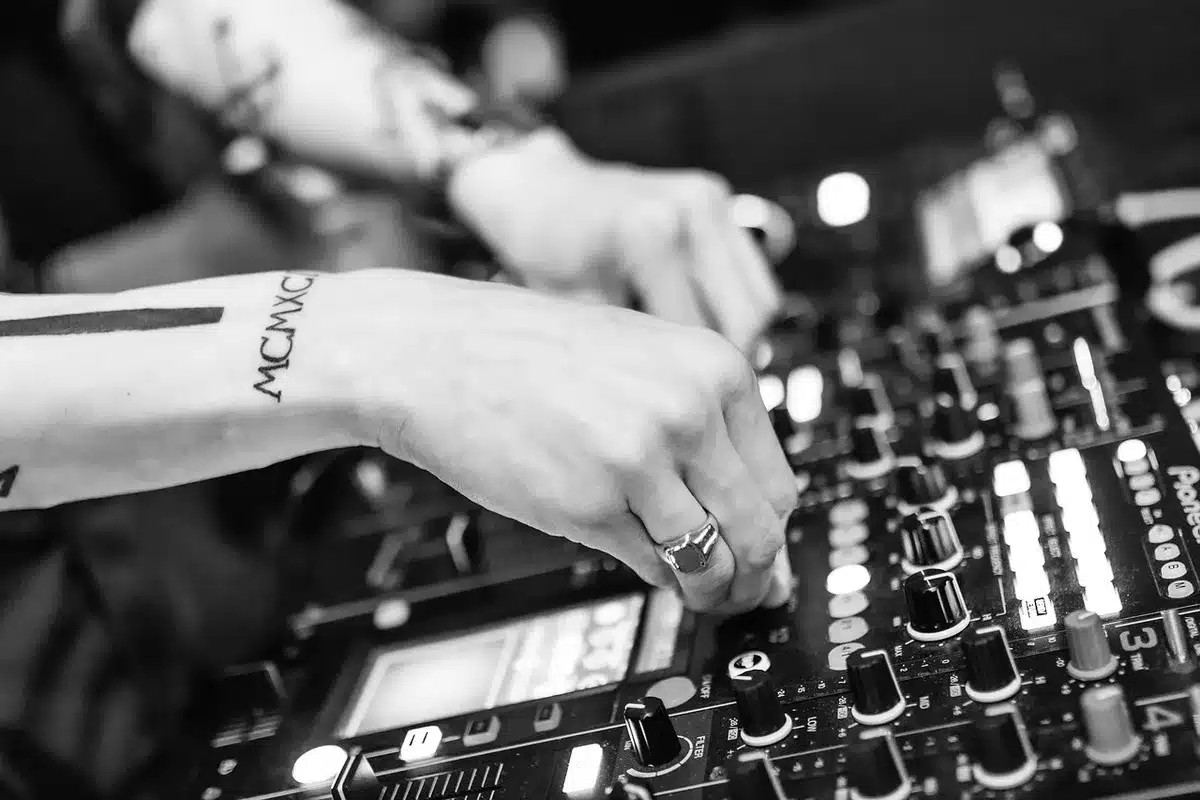 Producer at a mixing console during a studio session