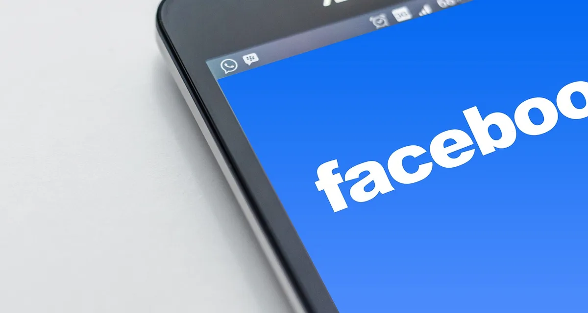 Hands holding a phone showing a social media feed reacting to a clip