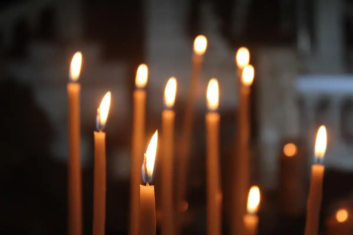 Community members holding a candlelight vigil inside a church offering legal help