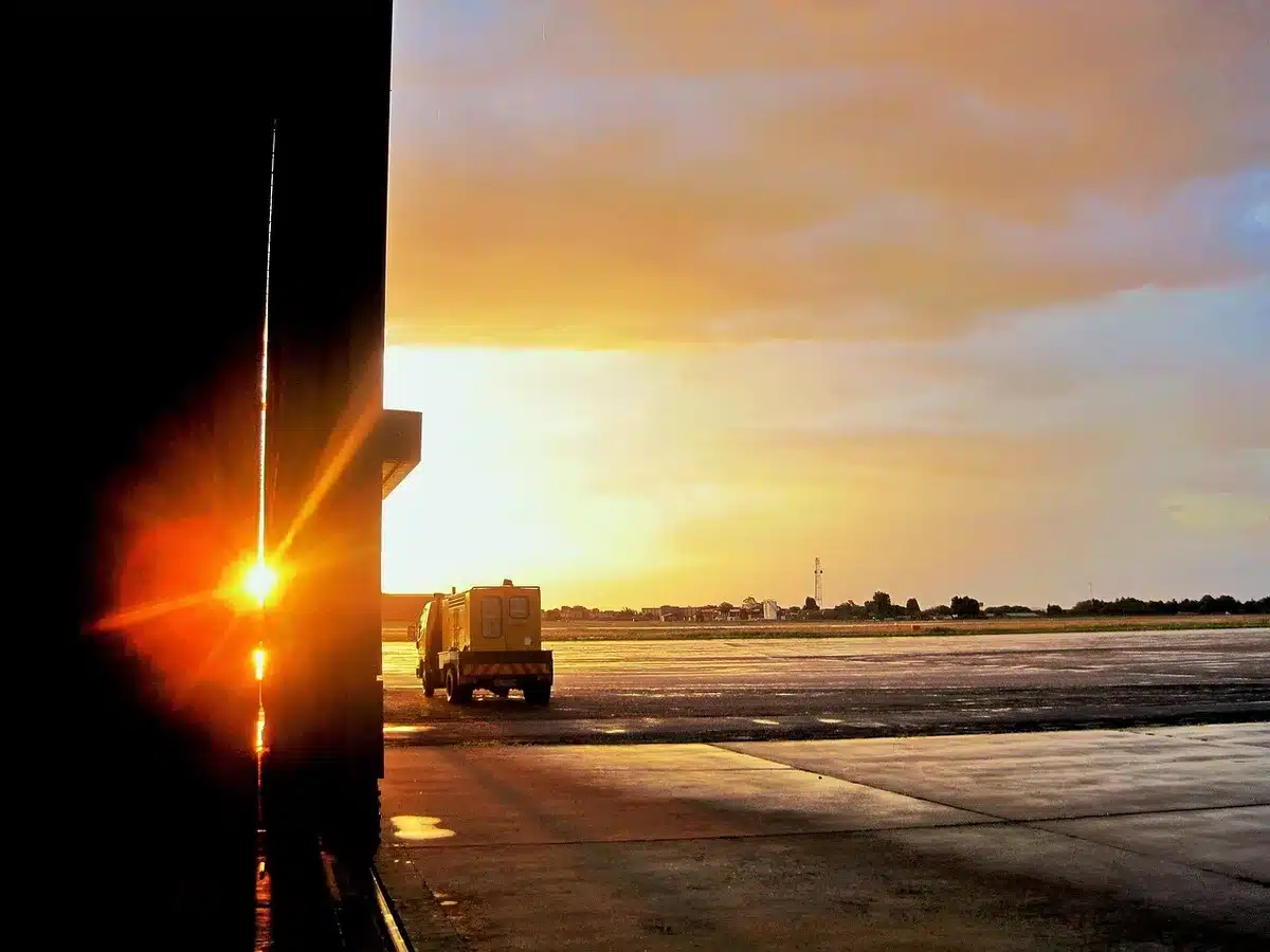 Empty catering cart near aircraft on airport tarmac