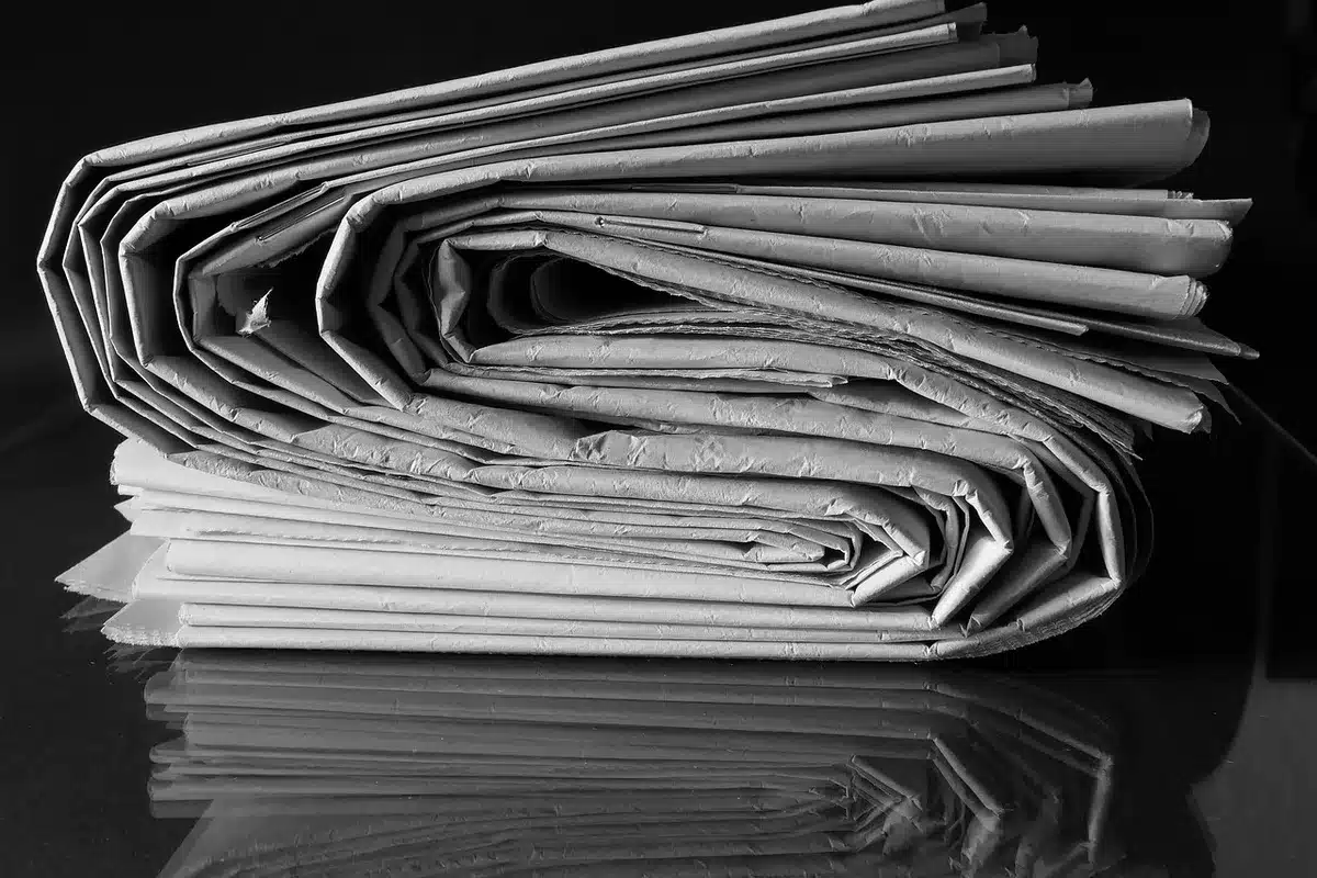 Journalist reviewing documents and fact-checking sources at a desk