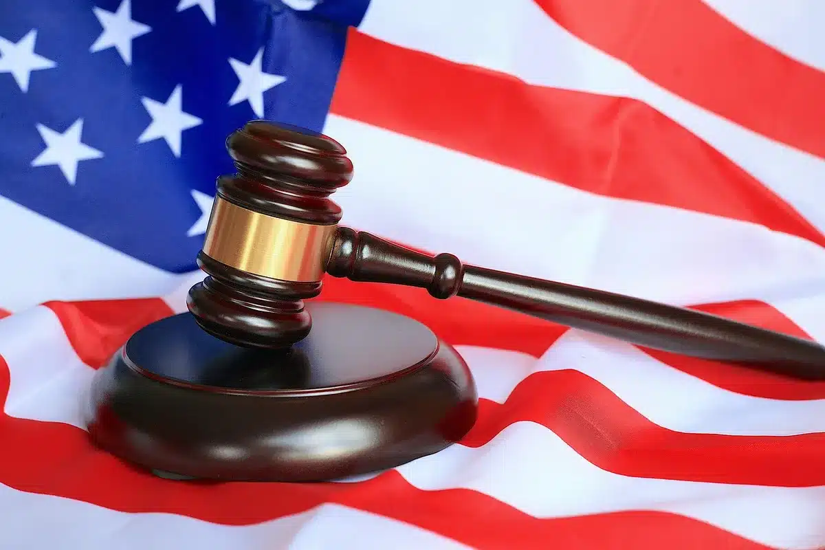 Courtroom setting with legal documents and indictment papers on a desk