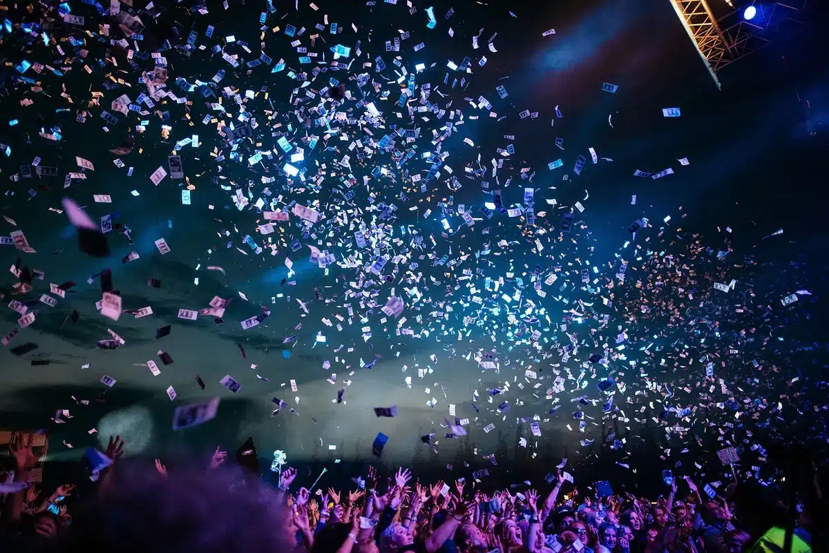 Rotating mosh pit at a dimly lit concert seen from the side
