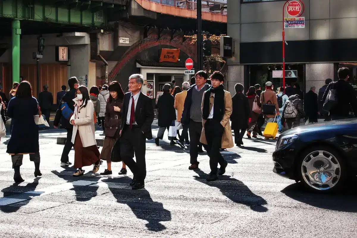 Crew filming on a busy Japanese street with handheld camera gear