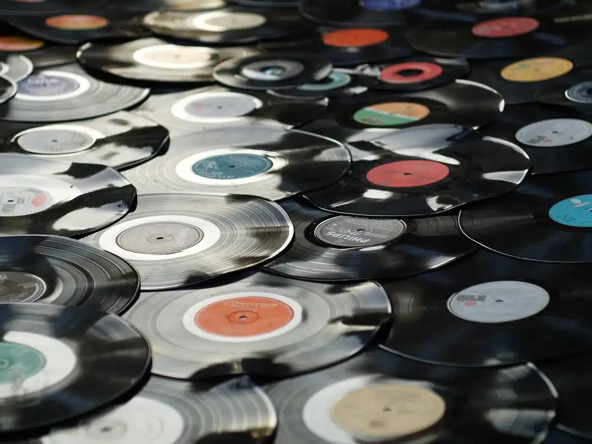 Anonymous hands searching through vinyl records in a crate