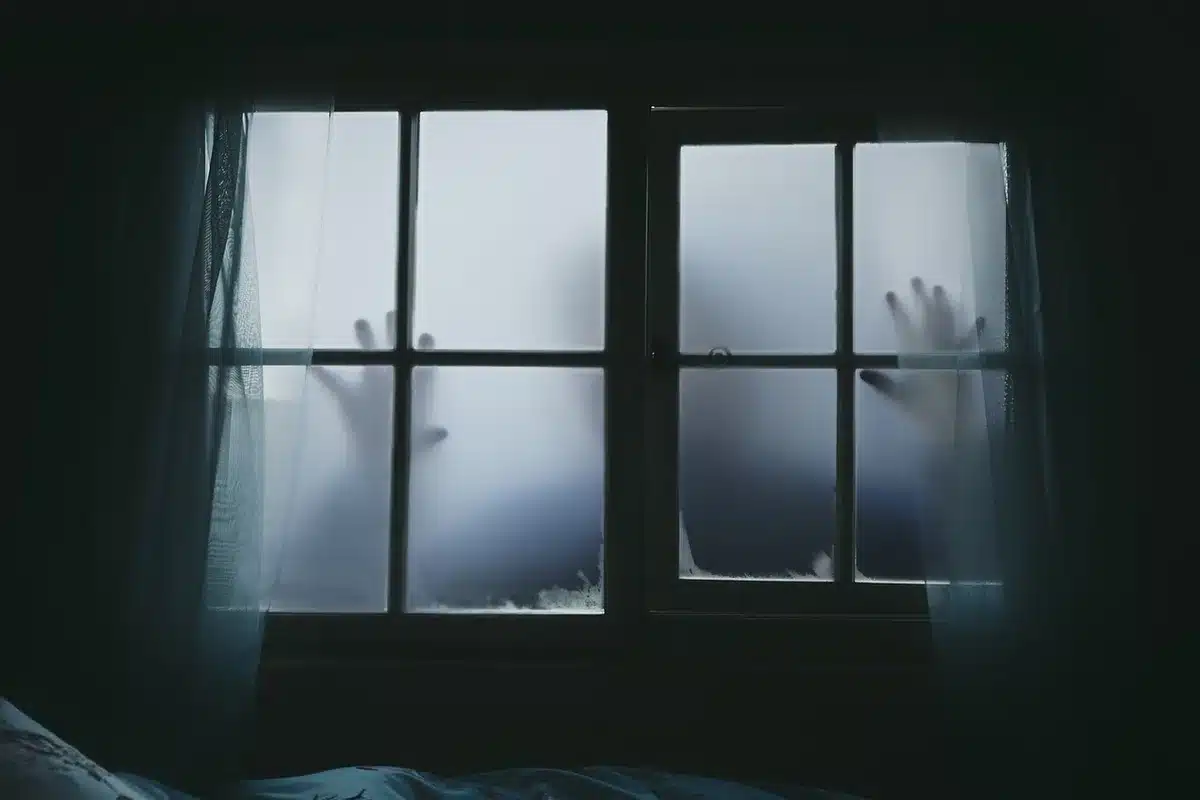 Silhouetted father and adult son at a window, hinting at testimony and family struggle