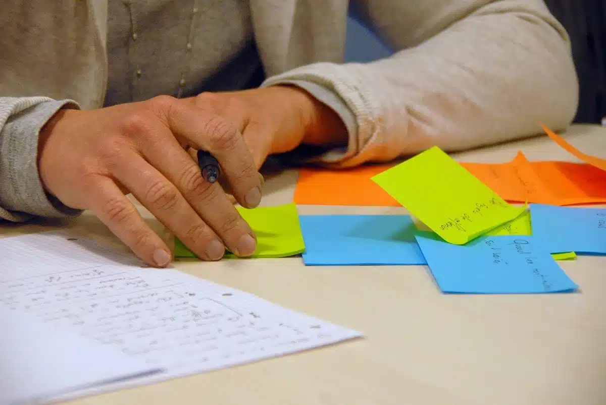 Person jotting quick notes for jokes on a notepad