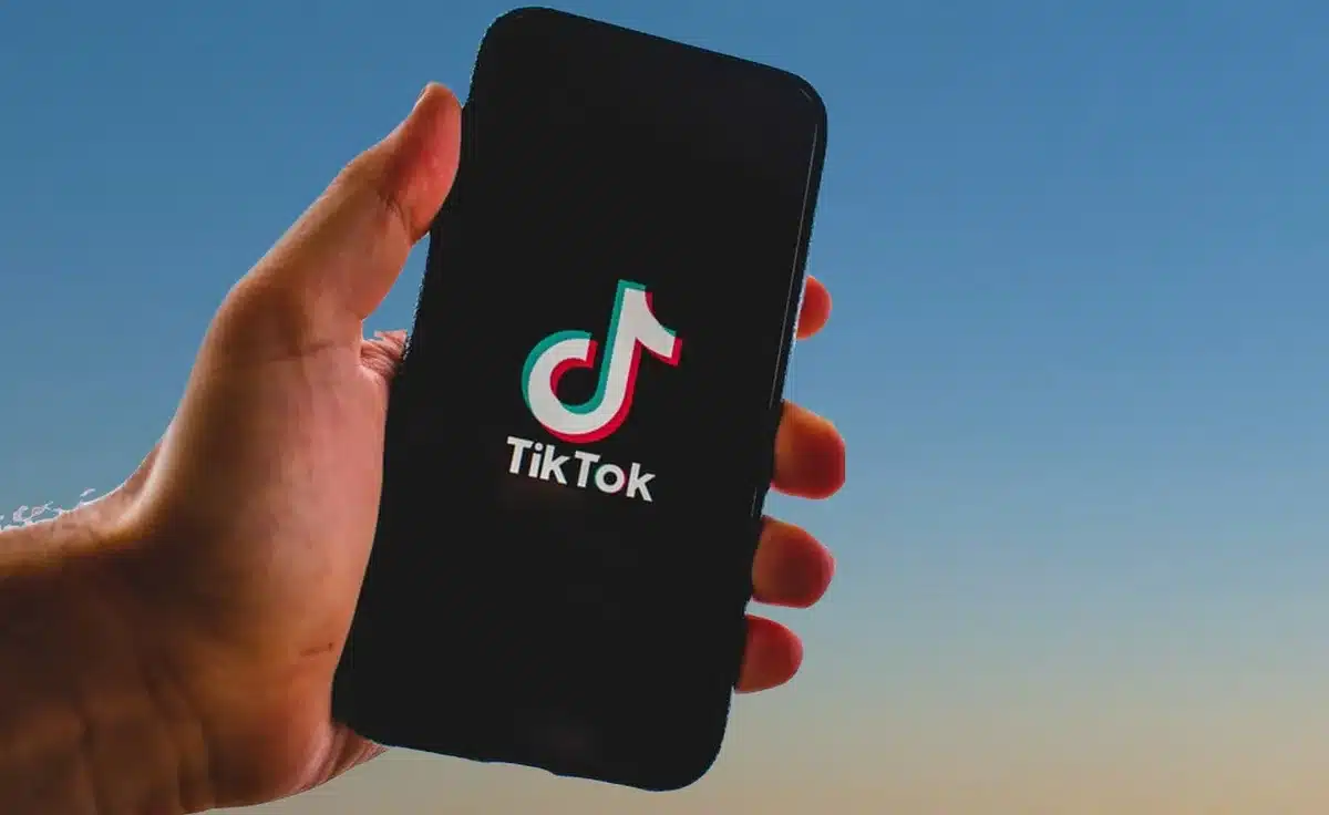 Vinyl records beside a smartphone showing a short-form video app, symbolizing discovery loops