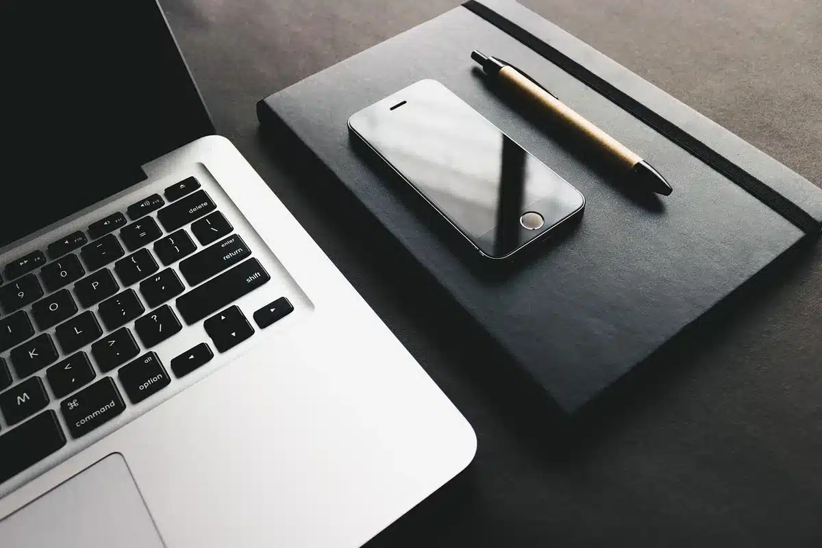 Two thin laptops displayed on a store table without logos