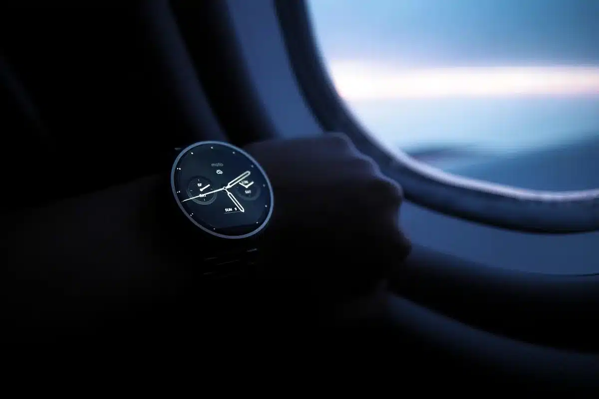 Silhouette of a flight attendant's hands with headset and notepad in an airplane cabin