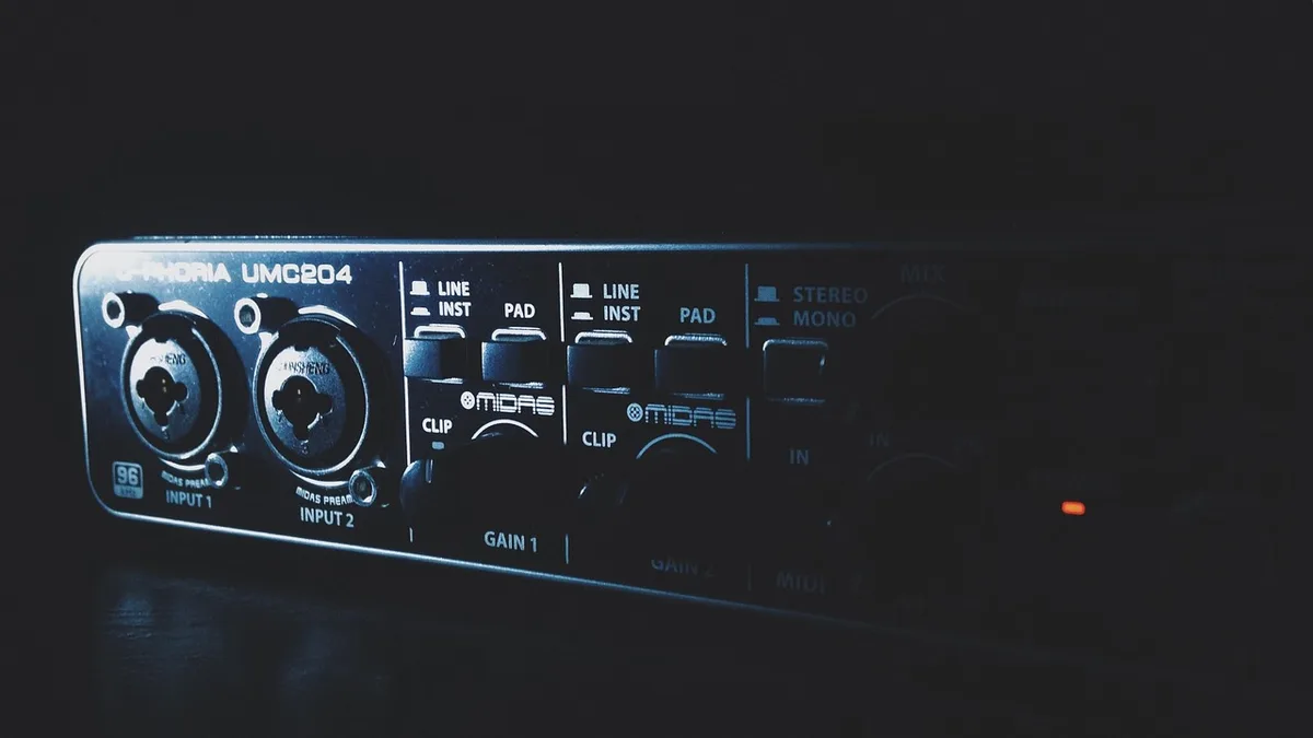 Lo‑fi studio corner with vintage amp and microphone reflecting raw production