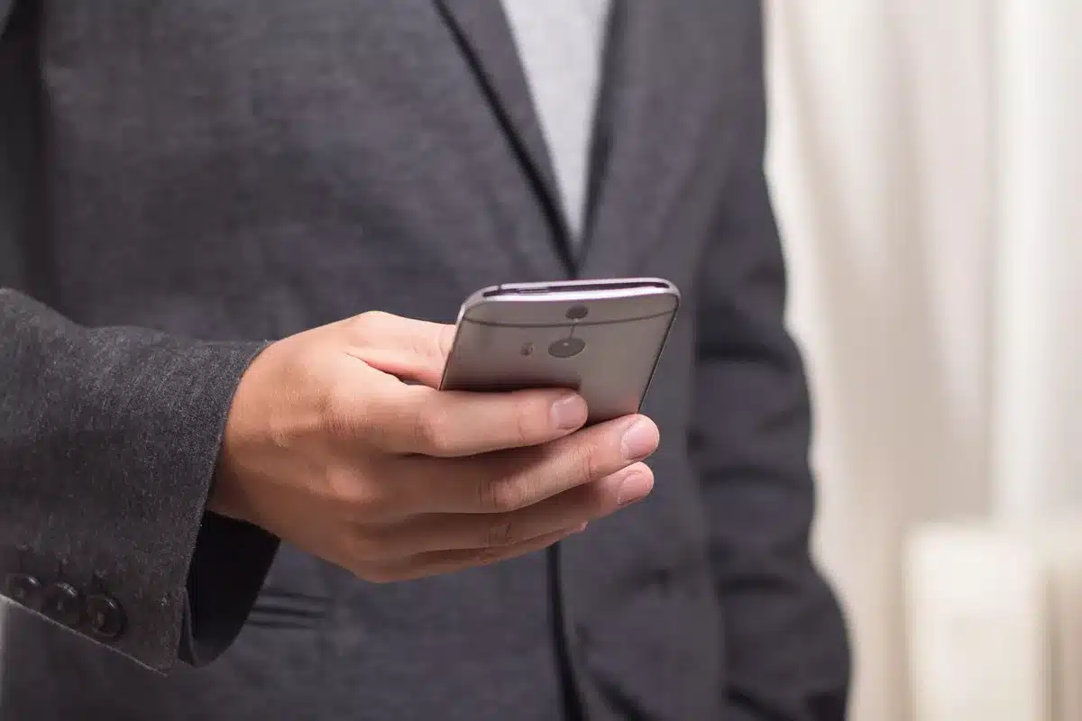 Mobile phone screen with anonymous messages representing rapid online harassment
