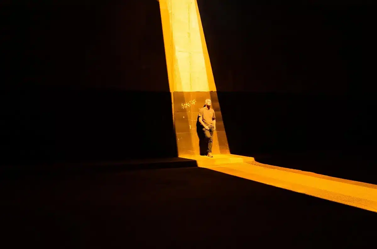 Silhouetted person texting alone at night with phone glow