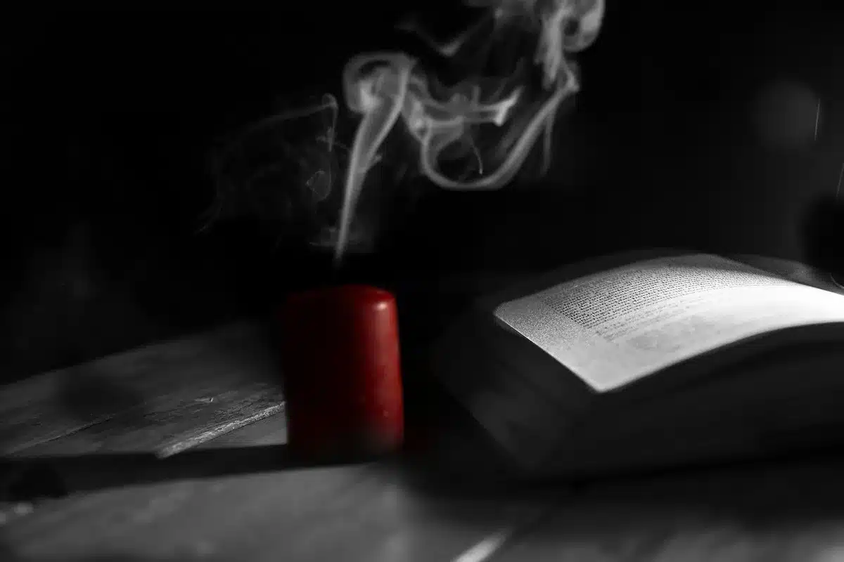 Three teens gathered with spellbooks and candles suggesting witch training and friendship