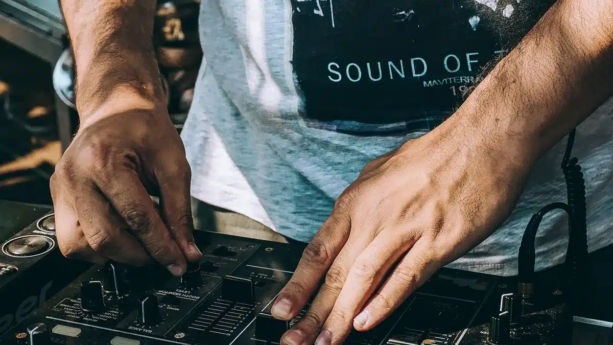 Turntables and mixer in a 1980s-style club booth
