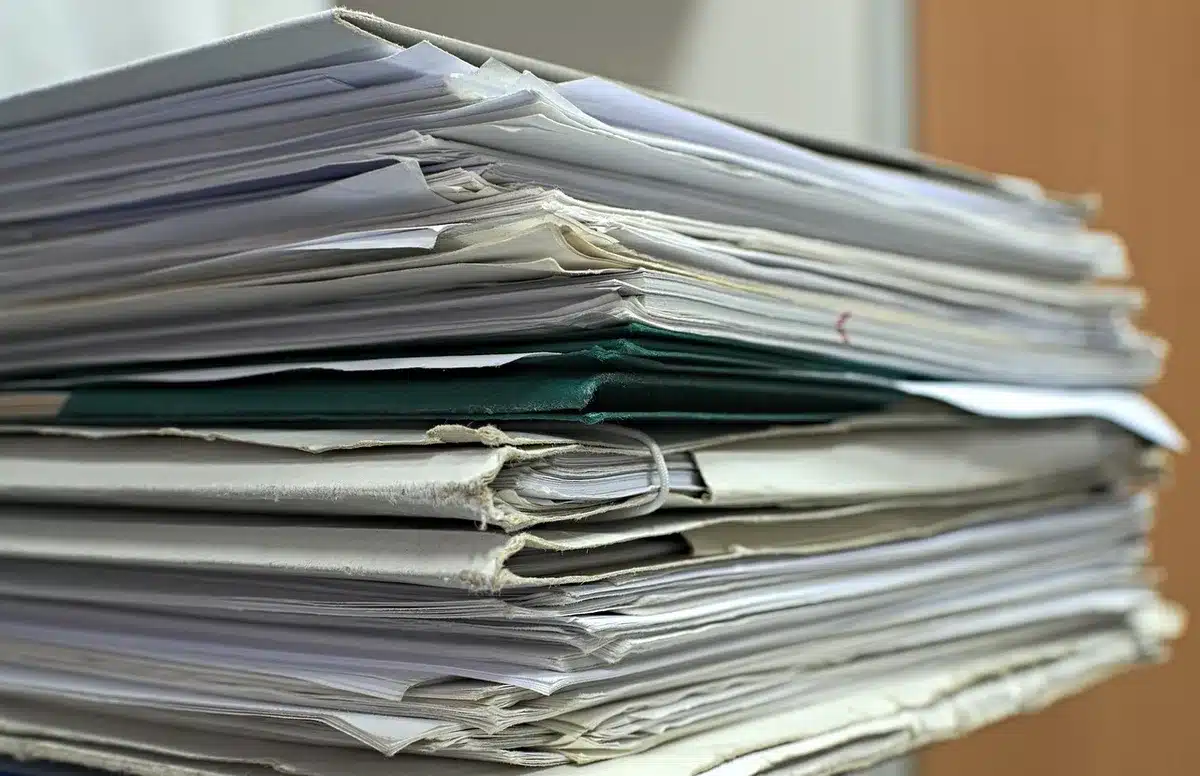 Stack of court filings and legal documents on a courtroom desk