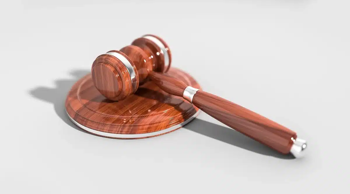 Judge's gavel beside legal papers on a courtroom desk
