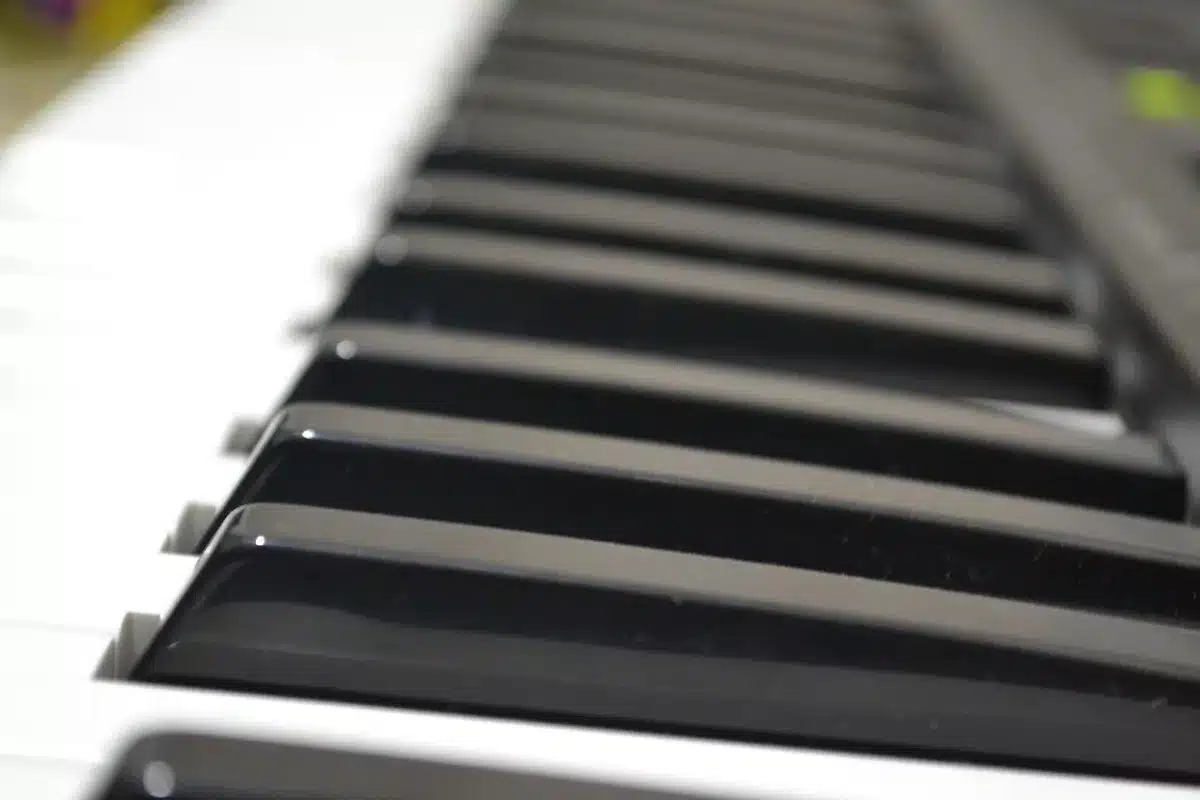 Close-up of hands playing a jazz piano in a dim club