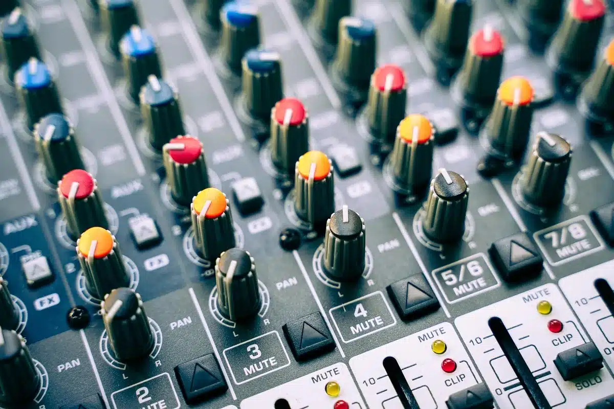 Layered guitars and pedals in a rehearsal space showing textured indie-emo production