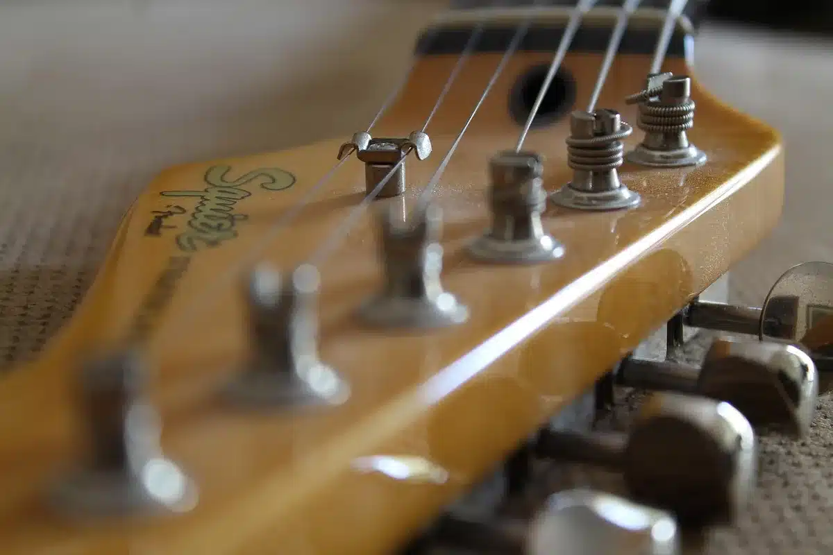 Close-up of hands strumming an acoustic guitar, intimate warm tones