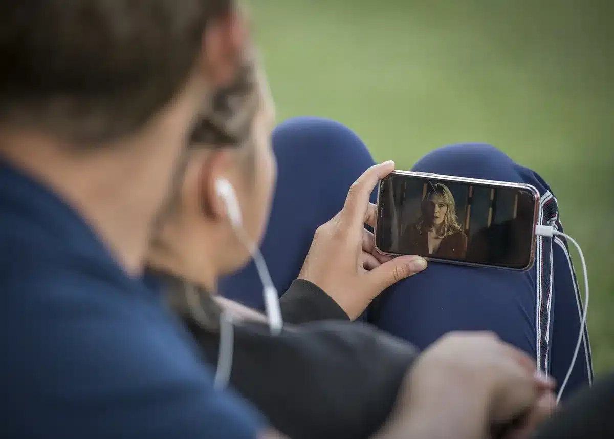 Audience phones and social feeds showing viral video reactions