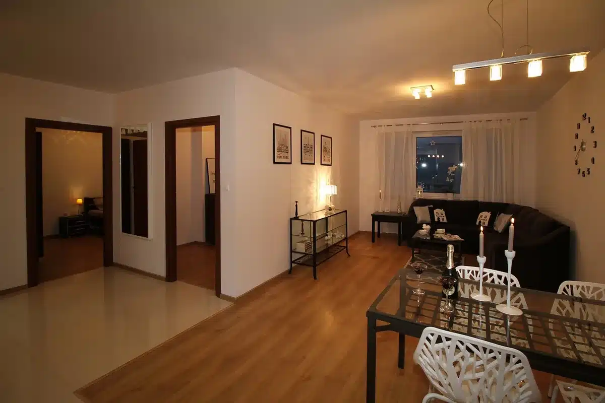 Narrow apartment stairwell with armchair and lit candles on a windowsill