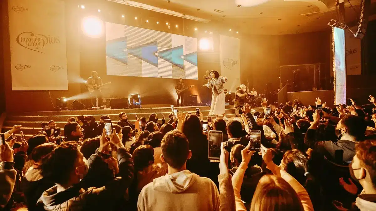 Lead singer performing on a small stage with an intimate audience