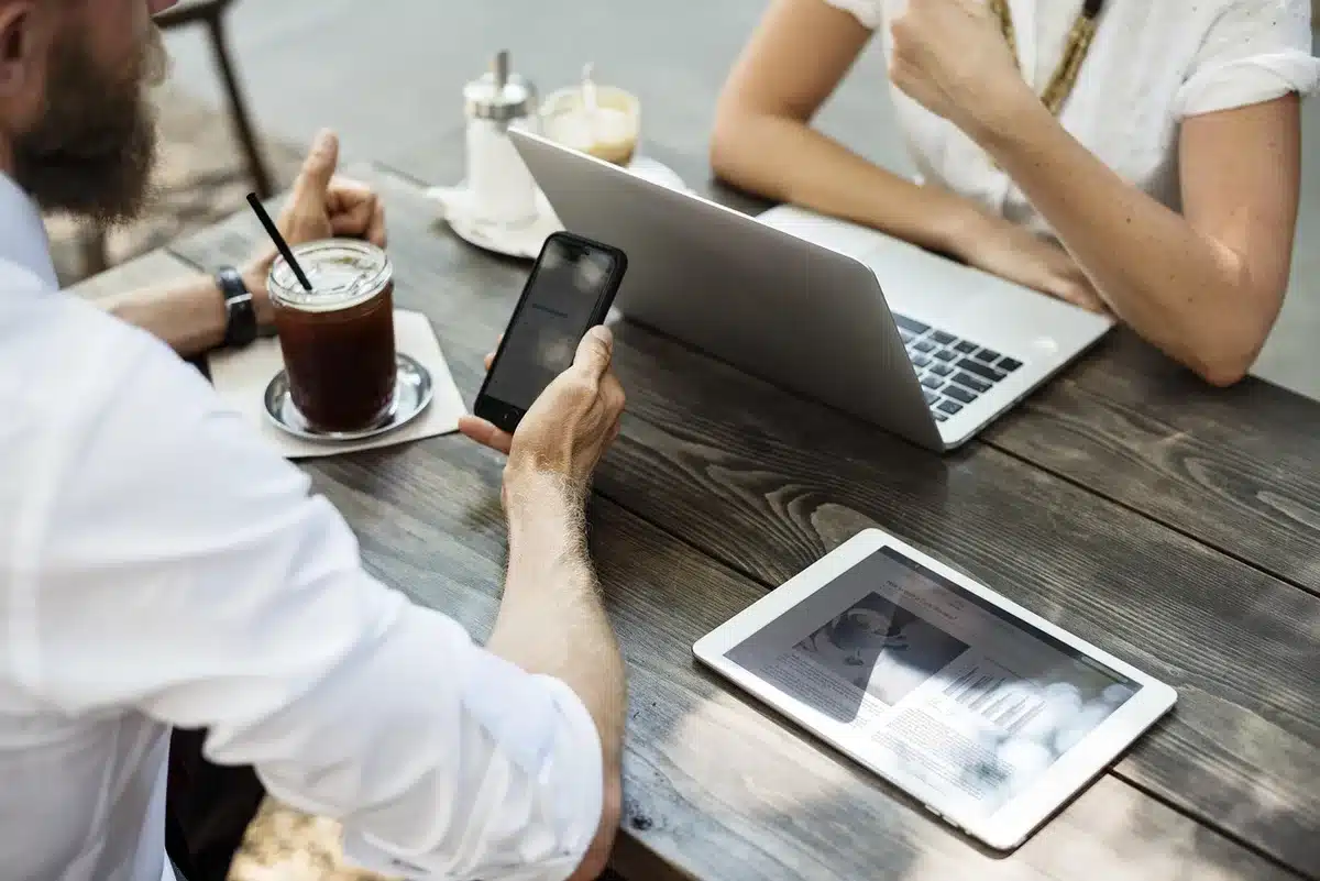 Person using a laptop with a VPN in a café to mask location