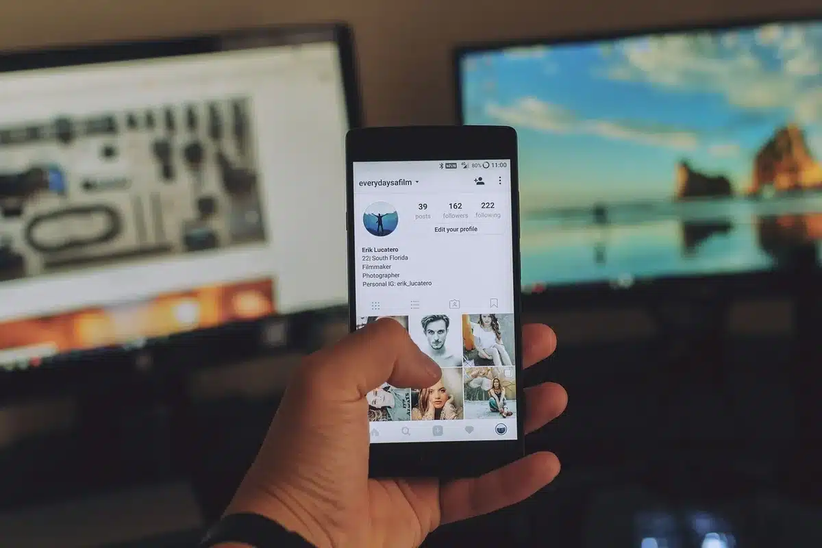 Close-up of a smartphone showing a social media thread on screen