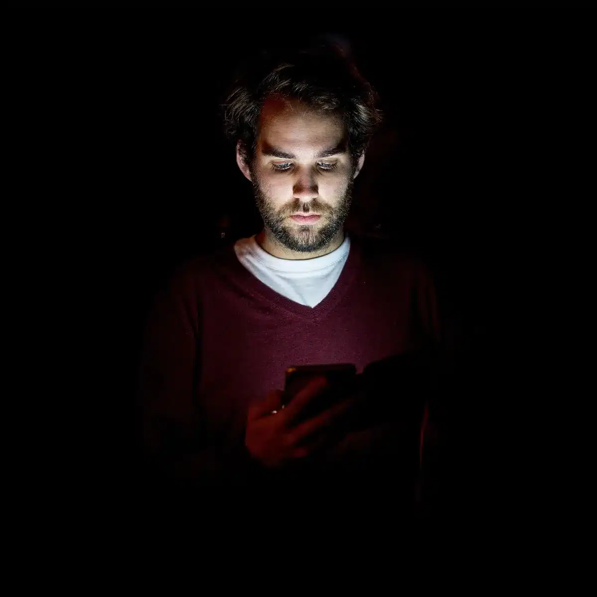 Hands holding smartphones showing social media feeds and comments