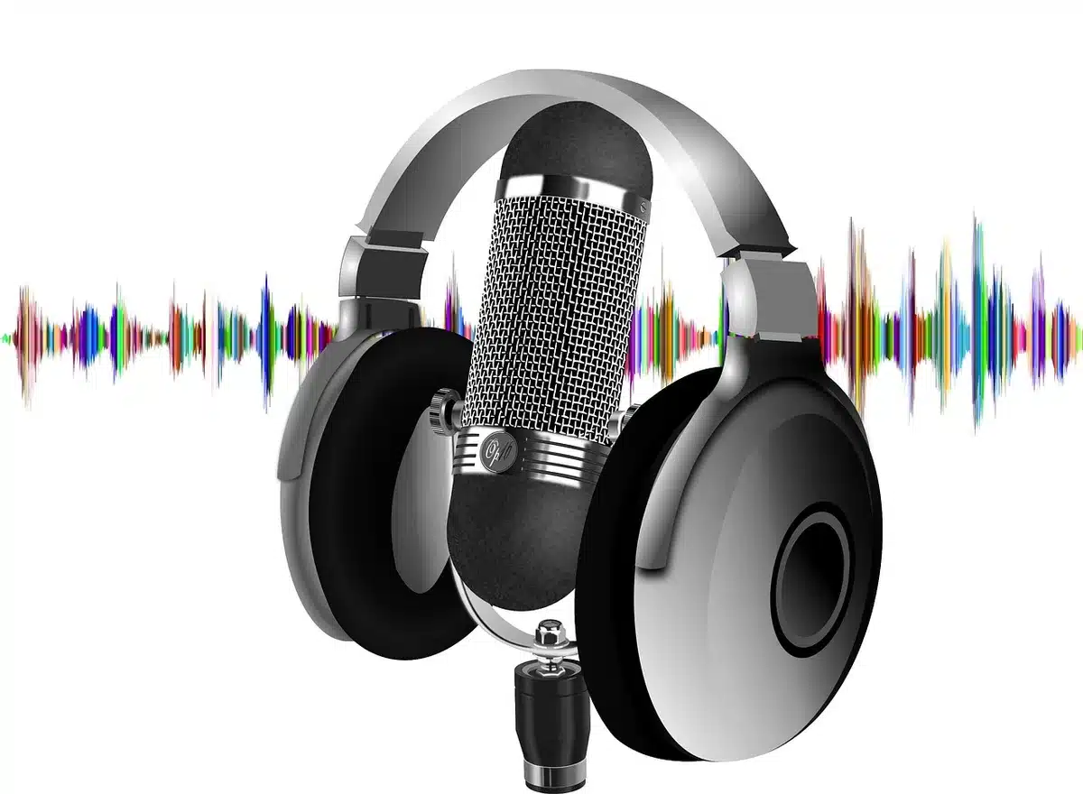 Silhouette of a podcast microphone and headphones on a studio table, turned-away host implied