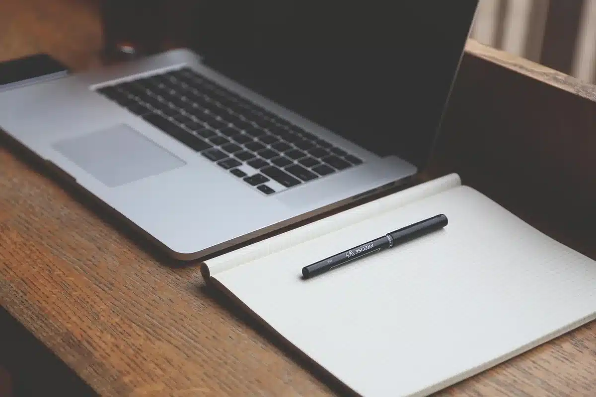 Songwriter writing lyrics in a notebook, pen in hand