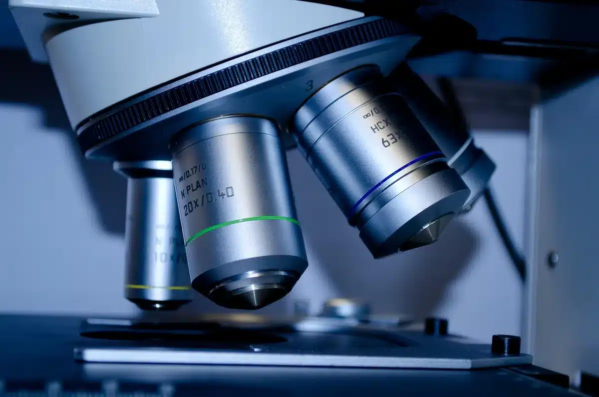 Forensic lab bench with testing equipment and microscopes