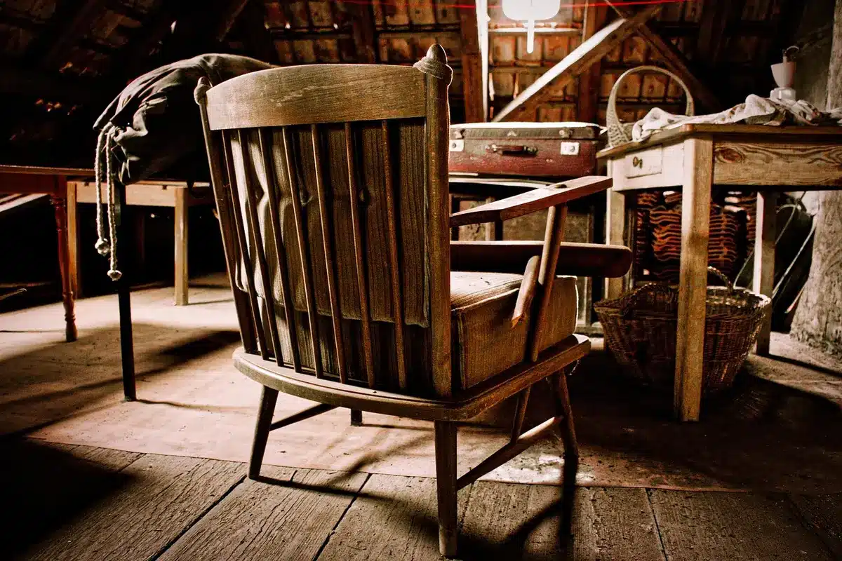 Attic table with aged manuscript pages, trumpet case and folded jacket