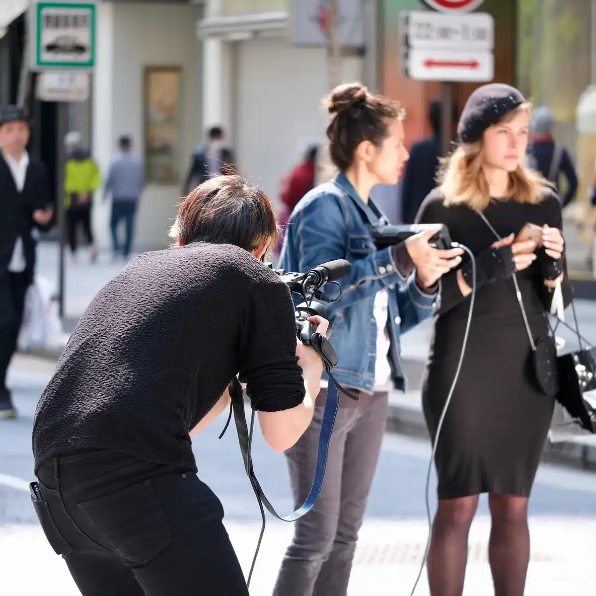 Small documentary crew filming discreetly in an indoor location