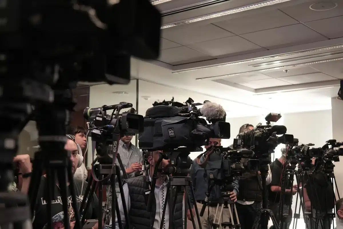Cluster of microphones at a press scrum outside a courthouse