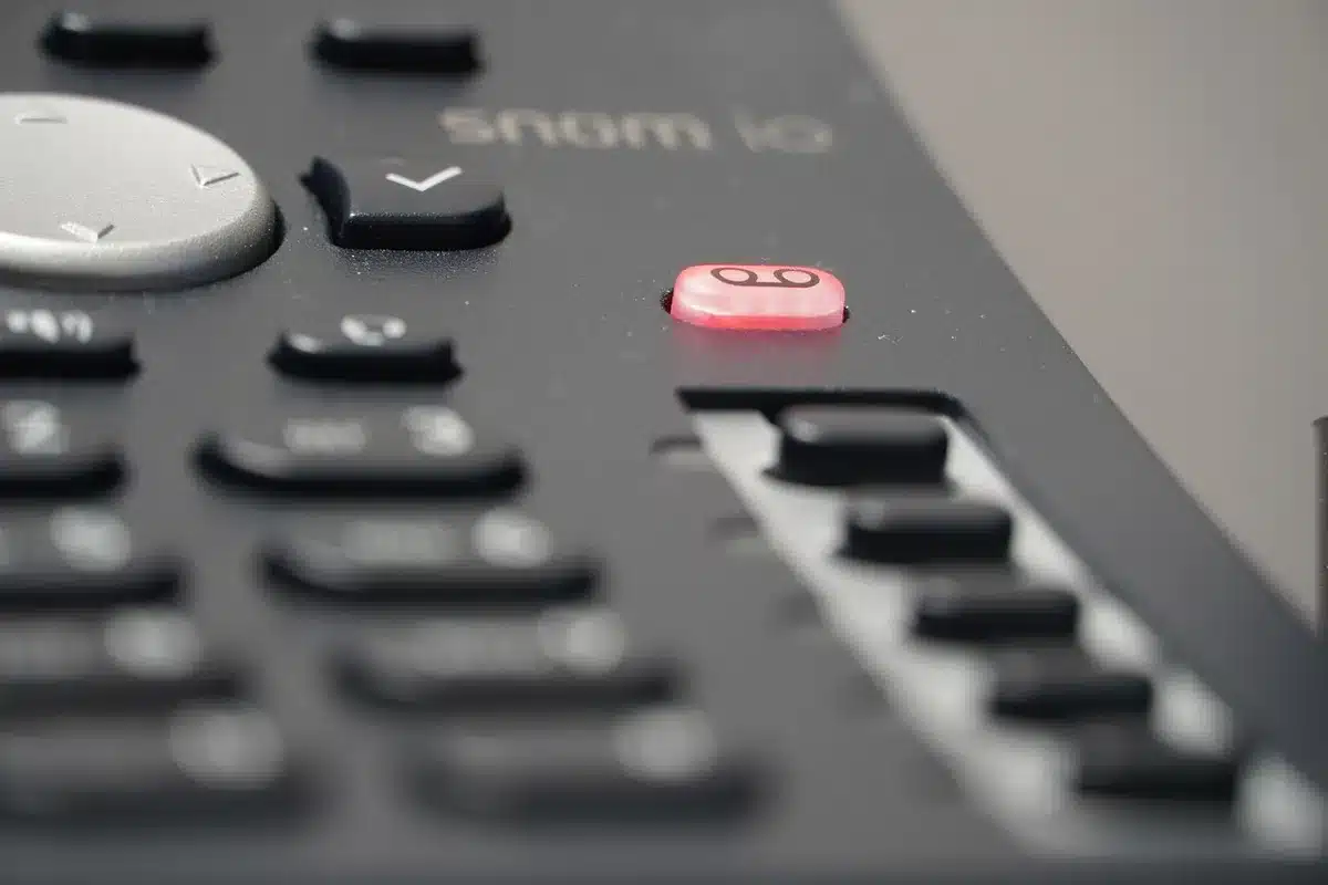 Close-up of a smartphone showing a voicemail notification in a city apartment