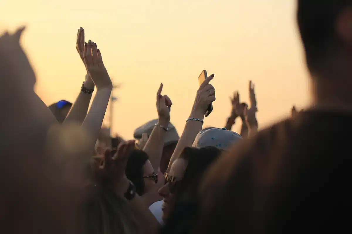 Crowd watching immersive LED dome with giant abstract creature projection